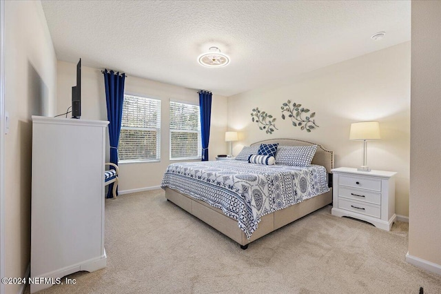 carpeted bedroom with a textured ceiling