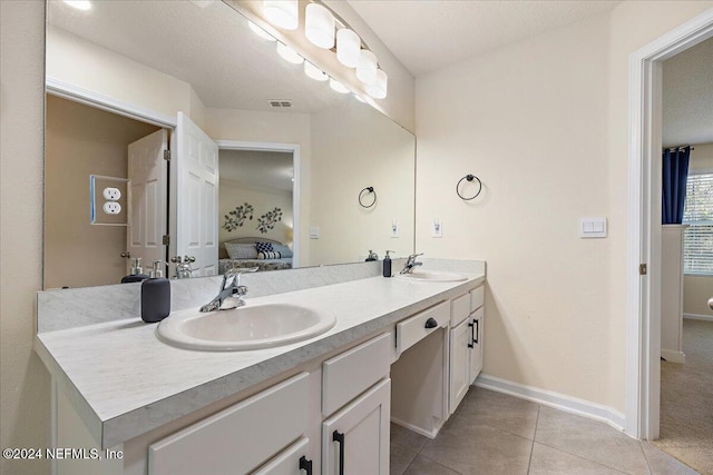 bathroom featuring vanity, a textured ceiling, and tile patterned floors