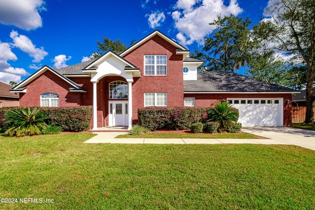 front facade with a front yard and a garage