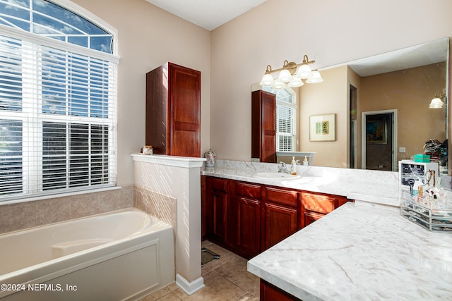 bathroom featuring vanity, a tub to relax in, and tile patterned floors