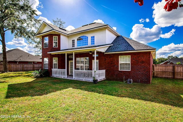 back of house featuring a yard