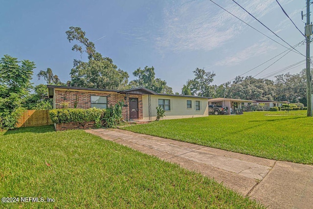 ranch-style home with a front lawn