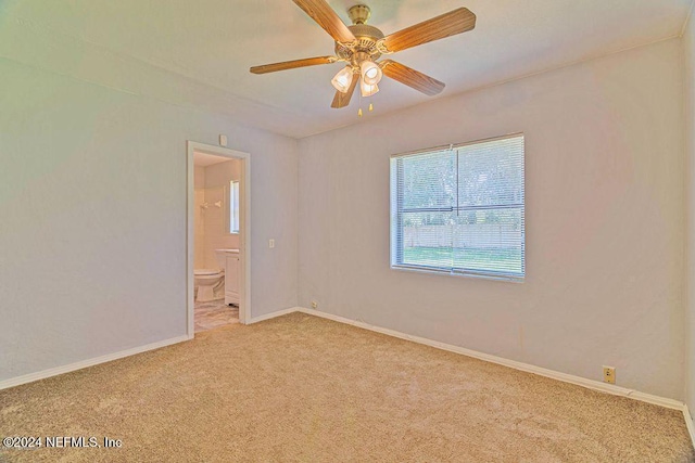 unfurnished room with light colored carpet and ceiling fan