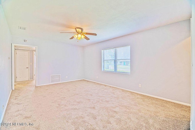 unfurnished room with light colored carpet and ceiling fan