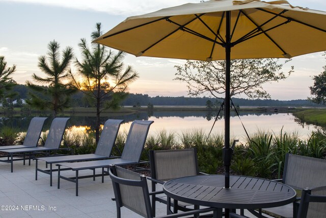 view of patio / terrace with outdoor dining space and a water view