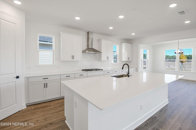 2523 Trailmark Dr, Saint Augustine, FL 32092 - kitchen with wall chimney range hood, a sink, visible vents, dark wood-style flooring, and gas cooktop