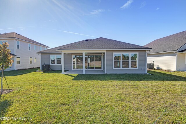 2523 Trailmark Dr, Saint Augustine, FL 32092 - rear view of house featuring a shingled roof, a patio area, cooling unit, and a lawn