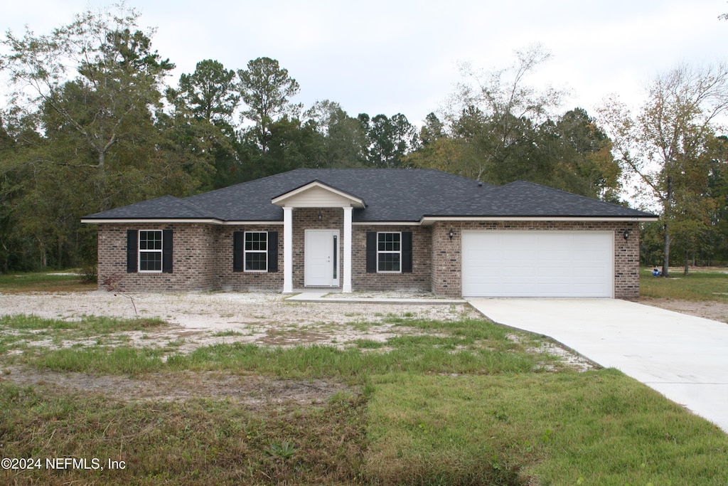 ranch-style home with a front yard and a garage