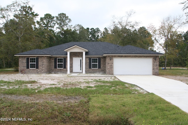 ranch-style home featuring a front yard and a garage