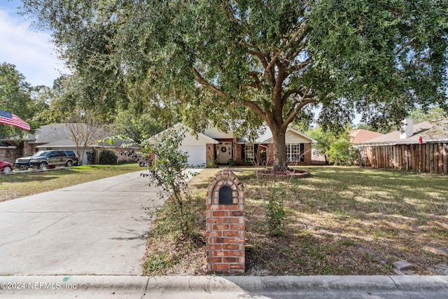 view of front of property with a garage and a front lawn