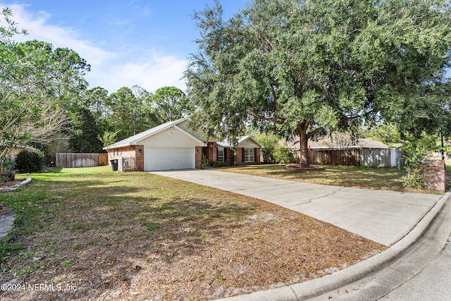 single story home with a garage and a front yard