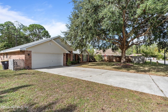 ranch-style house with a garage and a front yard