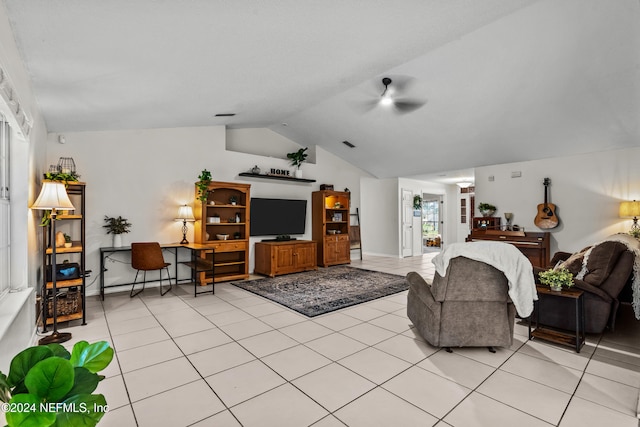 tiled living room with ceiling fan and vaulted ceiling