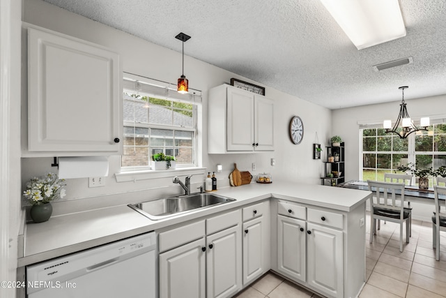 kitchen with a healthy amount of sunlight, kitchen peninsula, sink, and white dishwasher