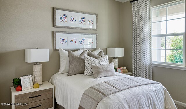 bedroom featuring multiple windows