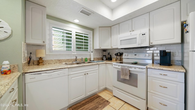 kitchen featuring white cabinets, white appliances, tasteful backsplash, and sink