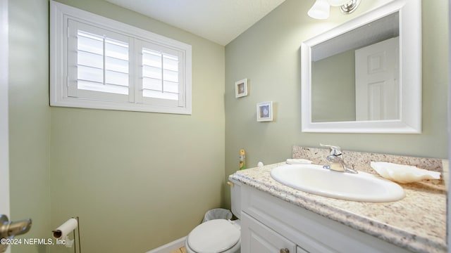 bathroom featuring vanity and toilet