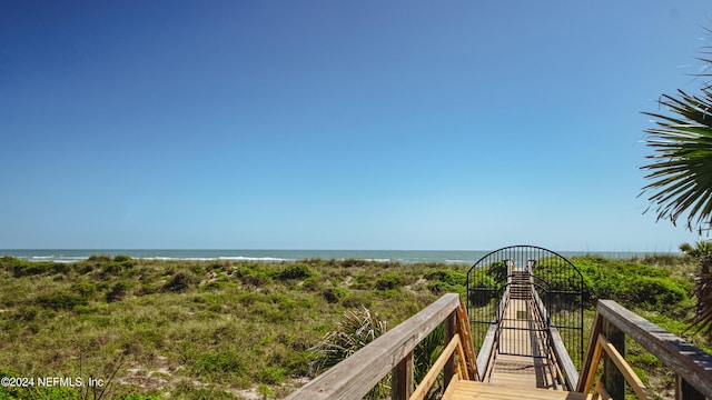 surrounding community featuring a view of the beach and a water view