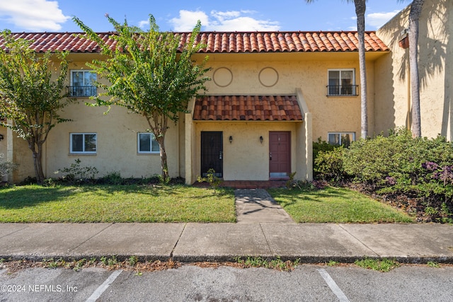 mediterranean / spanish home featuring a front yard