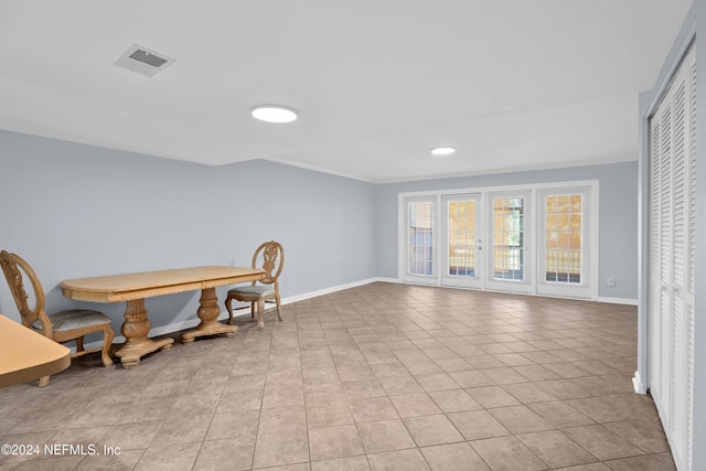 interior space featuring french doors and light tile patterned floors