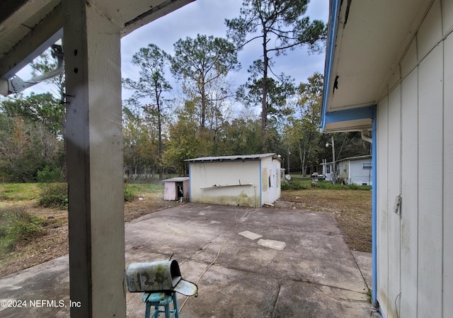 view of patio / terrace featuring a storage shed