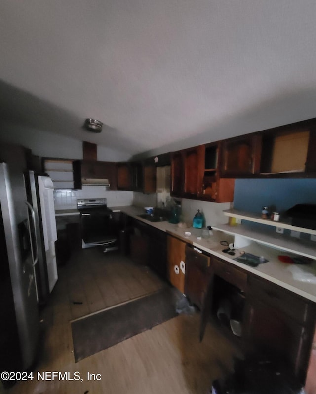 kitchen with cooktop, stainless steel refrigerator, black electric range oven, dark wood-type flooring, and lofted ceiling