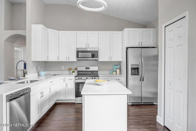 kitchen featuring lofted ceiling, dark hardwood / wood-style flooring, appliances with stainless steel finishes, white cabinetry, and sink