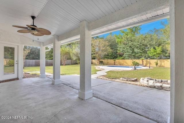 view of patio featuring a fenced in pool and ceiling fan