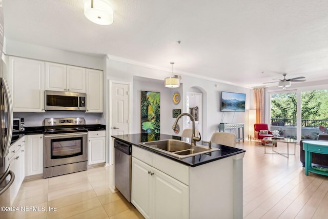 kitchen with white cabinetry, appliances with stainless steel finishes, sink, and pendant lighting