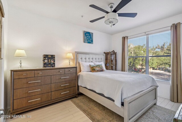 bedroom featuring light hardwood / wood-style floors and ceiling fan