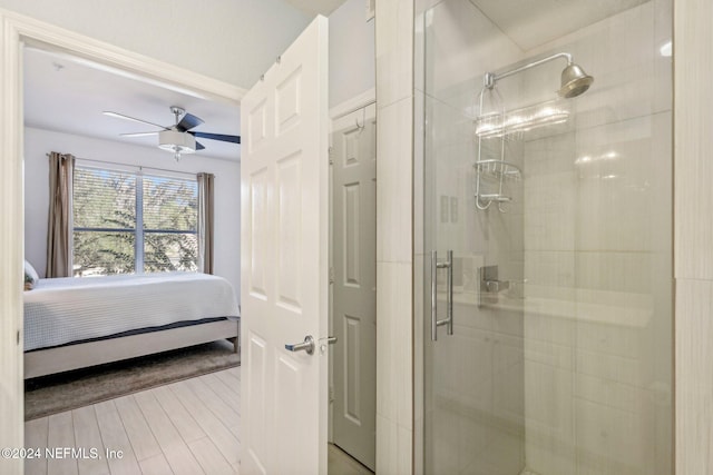 bathroom featuring ceiling fan and an enclosed shower