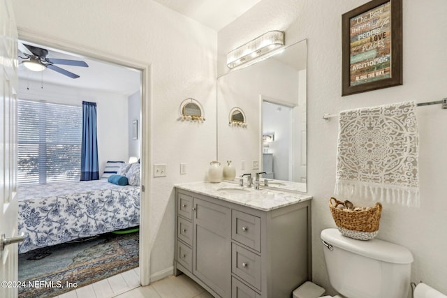 bathroom featuring vanity, toilet, tile patterned flooring, and ceiling fan