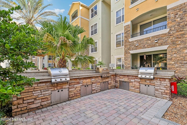 view of patio featuring a balcony and area for grilling