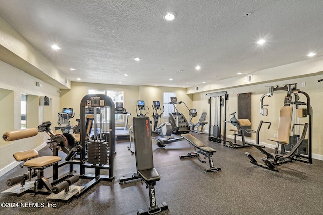 workout area featuring a textured ceiling