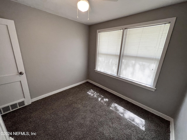 empty room featuring carpet and ceiling fan