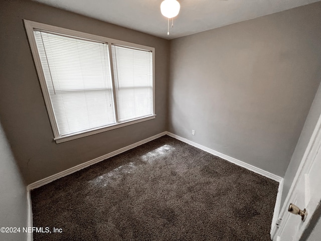 carpeted spare room with ceiling fan