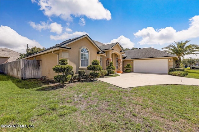 ranch-style home featuring a front lawn and a garage