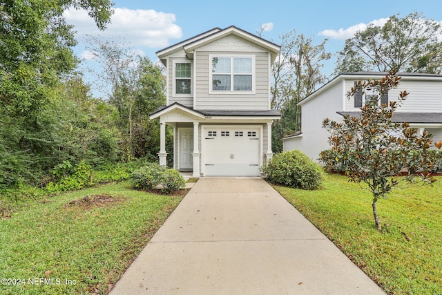 view of front of house with a front lawn and a garage