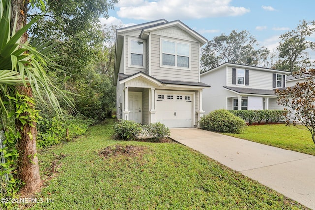 view of front of property featuring a garage and a front lawn