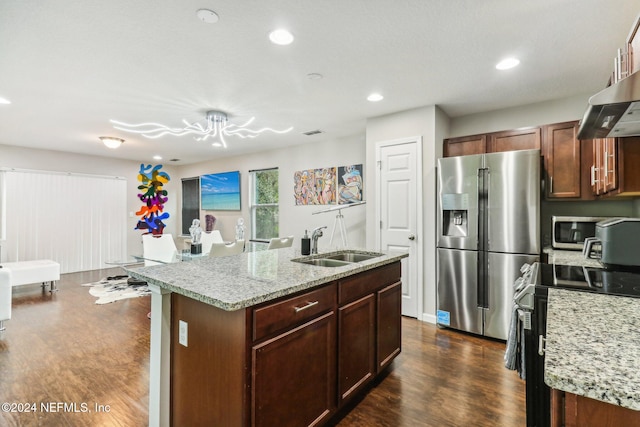 kitchen featuring stainless steel appliances, a center island with sink, sink, and dark hardwood / wood-style flooring