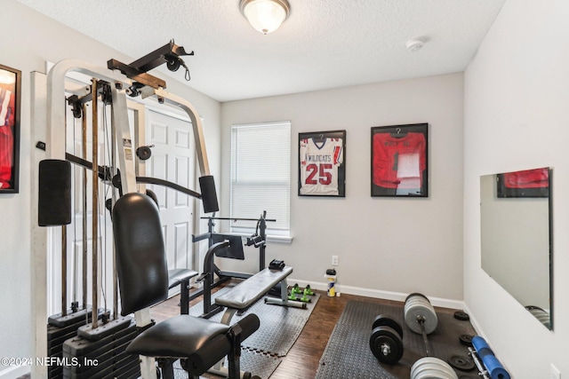 workout room with hardwood / wood-style floors and a textured ceiling