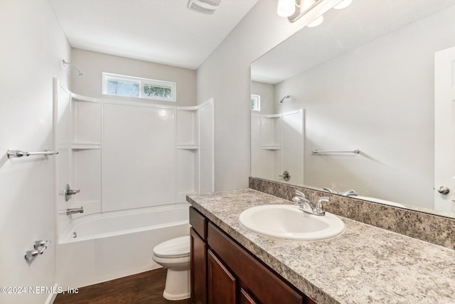 full bathroom with vanity, wood-type flooring, toilet, and shower / bathtub combination