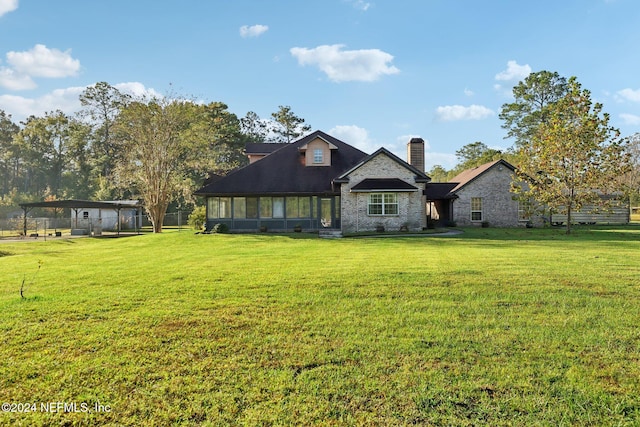 view of front of house with a sunroom and a front yard