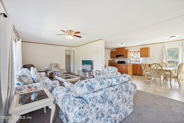 living room featuring ceiling fan and ornamental molding