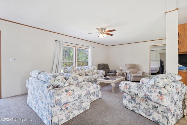 living room with crown molding, carpet flooring, and ceiling fan