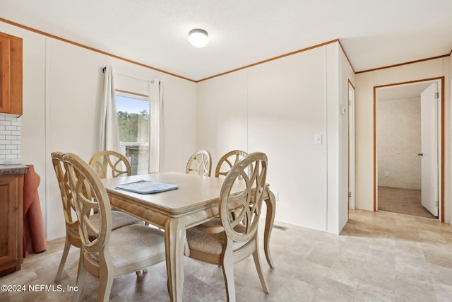 dining area featuring crown molding and a textured ceiling