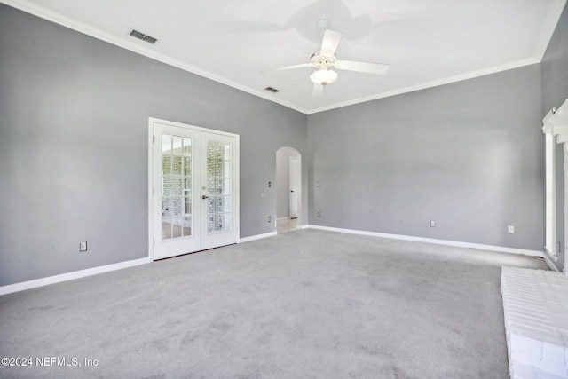 carpeted empty room featuring french doors, ceiling fan, and ornamental molding