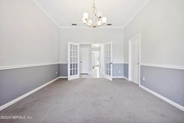 unfurnished room featuring french doors, carpet flooring, and crown molding