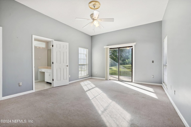 unfurnished bedroom featuring ceiling fan, access to outside, ensuite bathroom, and light colored carpet