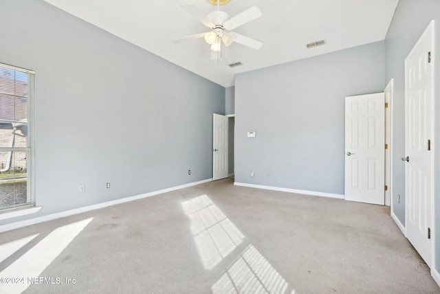 unfurnished bedroom featuring light carpet and ceiling fan